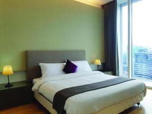 a bedroom with a large bed with a large window at KLCC Suites at Platinum in Kuala Lumpur