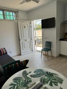 a living room with a table and a couch and a door at El Molino in La Aldea de San Nicolas
