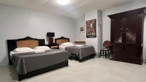 Postel nebo postele na pokoji v ubytování Hotel Capada