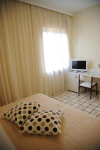 - une chambre avec un lit avec deux oreillers et un bureau dans l'établissement Via Capo Rooms, à Sorrente