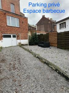 a driveway in front of a house with a garage at Zenitude in Jumet