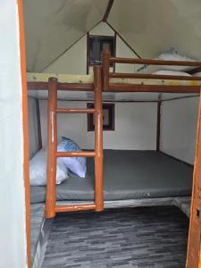 a couple of bunk beds in a room at Kua's Pad Batangas Kubo in Lian