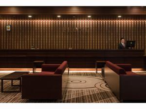 a man standing at a bar in a waiting room at ManyonoyuHotelKyotoEminence in Kyoto