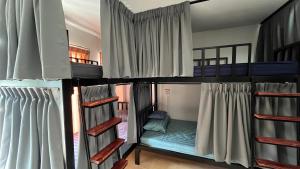 a group of bunk beds in a room at ALPHA Hostel Cafe&Bar in Ban Khlong Yai