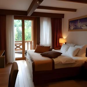 a hotel room with two beds and a window at Vucko Apartments B229 & B230 in Jahorina