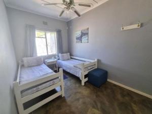a bedroom with two beds and a window at Karoo Nest - Calitzdorp in Calitzdorp