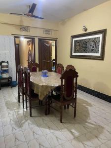 a dining room with a table and some chairs at Holiday Home in Khastobir Sylhet Town in Sylhet