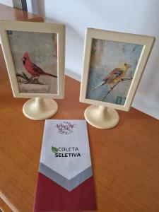two framed pictures of a bird on a table at Atlantic City Apart in Salvador