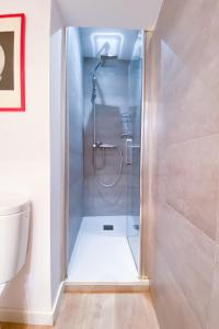 a shower with a glass door in a bathroom at Anna & Thomas - Sitges Center Apt in Sitges