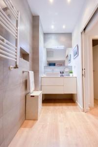 a white bathroom with a sink and a shower at Anna & Thomas - Sitges Center Apt in Sitges