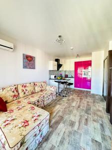 a living room with a couch and a kitchen at Апартамент Каскадас В54 in Sunny Beach