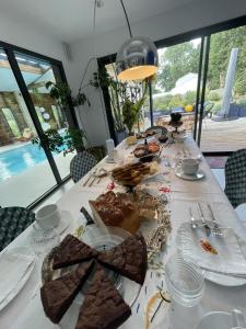 a long table with food on top of it at Villa NOVA in Saint-Hilaire-de-Riez