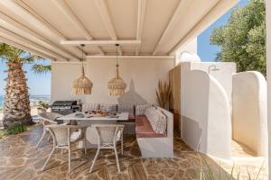 an outdoor dining area with a table and chairs at Helios Selene in Vívlos