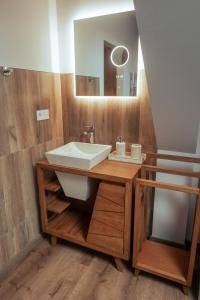 a bathroom with a sink and a mirror at Apartmán Rustikal in Trstěnice