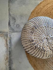 a basket sitting on top of a floor at Olive Tree Homes in Ios Chora
