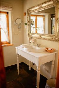 a bathroom with a white sink and a mirror at Osada Głęboczek. Vine Resort&Spa in Wielki Głęboczek