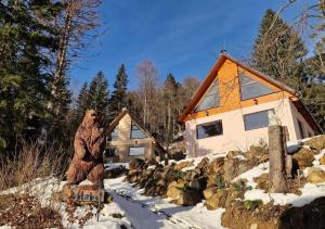 a statue of a bear in front of a house at BALABO Kuča in Horná Lehota