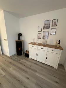 a living room with a fireplace and a wooden floor at Inseloase in Fehmarn +21 photos