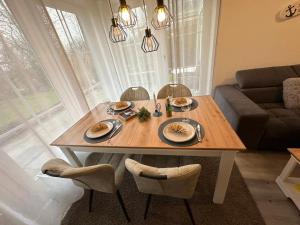 a table with plates of food on it in a living room at Inseloase in Fehmarn