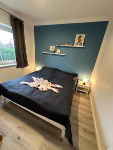 a bedroom with a bed with clothes on it at Inseloase in Fehmarn