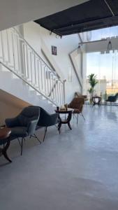 a lobby with chairs and tables in a building at شقق الايام المضيئة المخدومة in Najran