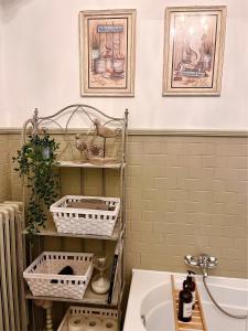a bathroom with baskets on a shelf next to a sink at Villa House and Garden B&B in Montichiari