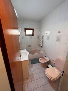 ein Badezimmer mit einem WC, einem Waschbecken und einer Badewanne in der Unterkunft Casa para 7 personas pileta in Monte Hermoso