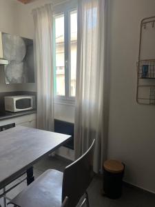 a kitchen with a table and a window at Appartement quartier la Timone in Marseille