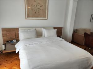 Postel nebo postele na pokoji v ubytování Ulysses Apartments Acropolis