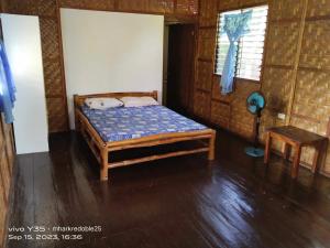a bedroom with a bed in a room at Casa James Apartment, Rooms , Pool and Restaurant in Siquijor