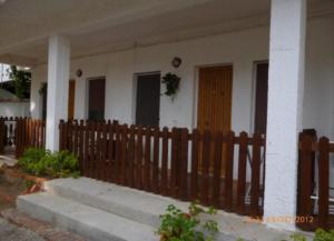 a wooden fence in front of a house at Residence La Quiete in Taureana