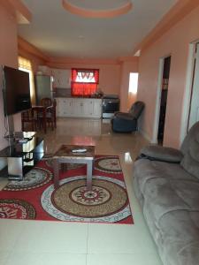 a living room with a couch and a table at SherNette Nest. in San Juan