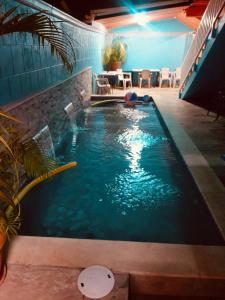 a swimming pool in the middle of a room at SherNette Nest. in San Juan