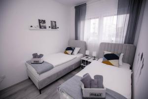 Apartman Day في تشاكوفيتش: غرفة معيشة بها سريرين وأريكة