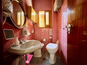 a bathroom with a white toilet and a sink at Casa Relax nel centro storico con posto auto in Vico Equense +23 photos