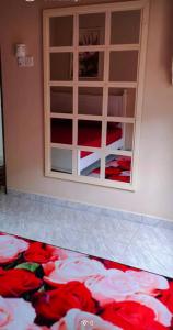 a room with a window with red sheets on the floor at Barokah Homestay Kijal in Kijal