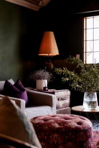 a living room with a couch and a lamp at Sweetfontein Boutique Farm Lodge in Britstown