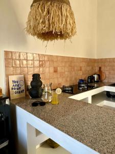 a kitchen with a counter top with at Trendy 1-Bedroom-Villa 'Lala' in Uluwatu in Jimbaran