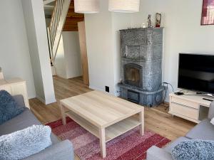 a living room with a fireplace and a couch and a table at Meil on in Kuressaare