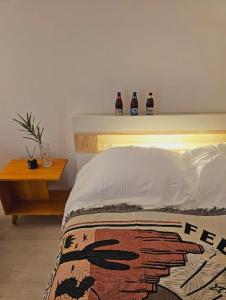 a bed with a head board with three bottles on it at Best memory 신축 지하철도보5분 인천공항버스1시간 김포공항지하철20분 용산KTX역40분 in Bucheon