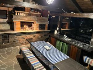eine Küche mit Kamin, Tisch und Stühlen in der Unterkunft Vila Eell in Borsa