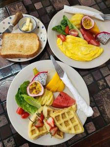 three plates of breakfast food on a table at Wayside Guesthouse in Chiang Mai