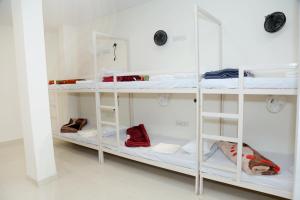 a room with white shelves with shoes on them at Charlie's Hostel By Purple India in New Delhi