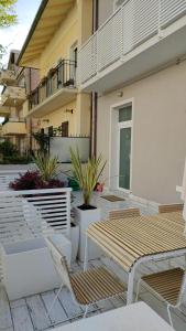 a patio with two chairs and a building at Appartamenti Diffusi di Villa Fiorita in Cattolica