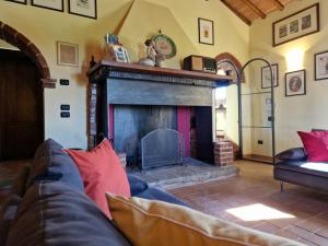 a living room with a couch and a fireplace at Podere Molinaccio in Panicale