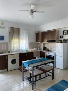 a kitchen with a table in the middle of it at Artemisia Apartment in Koskinou