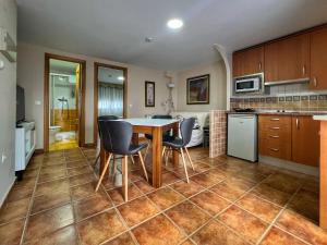 a kitchen and dining room with a table and chairs at Hostal la Colmena in Avila