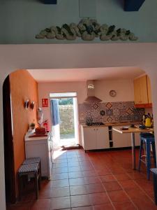 a kitchen with white cabinets and a table and a window at Casa Celia in Miranda del Rey