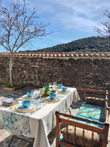 a table with plates of food on top of a stone wall at Casa Celia in Miranda del Rey