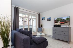 a living room with a couch and a dresser at Brücken-Butze Whg 12 Villa Strandburg in Kühlungsborn